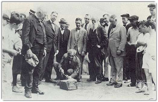 Henry Ford carving his initials on the stone which became the cornerstone of his manufacturing plant at Green Island, New York, which to this day is the key plant of Ford's Engine and Foundry Division